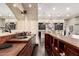 Stylish bar area with copper countertops, dark wood cabinetry, and an open view to the kitchen at 10638 E Hedgehog Pl, Scottsdale, AZ 85262