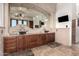 Lavish bathroom with dual vessel sinks, granite counters, beautiful lighting and large mirrors at 10638 E Hedgehog Pl, Scottsdale, AZ 85262