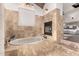 Elegant bathroom showcasing a fireplace, soaking tub, and marble tile at 10638 E Hedgehog Pl, Scottsdale, AZ 85262