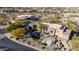 A tan desert home featuring natural stone accents surrounded by mature landscaping at 10638 E Hedgehog Pl, Scottsdale, AZ 85262
