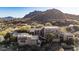 Expansive desert home with a multi-level design, desert landscaping, and scenic mountain backdrop at 10638 E Hedgehog Pl, Scottsdale, AZ 85262