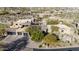 Tan home featuring a three-car garage, desert landscaping, and mature trees at 10638 E Hedgehog Pl, Scottsdale, AZ 85262