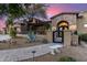 Stunning stone accented home featuring a gated courtyard, desert landscaping, and a brick walkway at 10638 E Hedgehog Pl, Scottsdale, AZ 85262