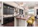 Spacious kitchen boasts dark cabinetry, a butcher block island, and stainless steel appliances at 10638 E Hedgehog Pl, Scottsdale, AZ 85262