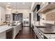 This kitchen offers dark cabinetry, stainless appliances, a breakfast bar and hardwood floors at 10638 E Hedgehog Pl, Scottsdale, AZ 85262