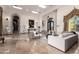 Elegant living room with marble flooring, stylish furniture, and arched doorways, creating a luxurious and inviting atmosphere at 10638 E Hedgehog Pl, Scottsdale, AZ 85262