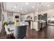 Open-concept living space with a fireplace, kitchen, dining area, and hardwood flooring at 10638 E Hedgehog Pl, Scottsdale, AZ 85262