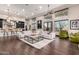 Bright and airy living room with large windows, modern decor, and seamless kitchen view at 10638 E Hedgehog Pl, Scottsdale, AZ 85262