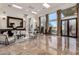 Spacious living room featuring marble floors, large windows, and comfortable seating, perfect for entertaining guests and relaxation at 10638 E Hedgehog Pl, Scottsdale, AZ 85262