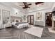 Primary bedroom features a tray ceiling, hardwood floors, and ensuite bath at 10638 E Hedgehog Pl, Scottsdale, AZ 85262