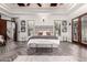 Spacious primary bedroom with a king bed, ensuite bathroom, and patio access at 10638 E Hedgehog Pl, Scottsdale, AZ 85262
