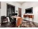 Bright home office featuring hardwood floors, modern desk, dual monitors, and a comfortable work space at 10638 E Hedgehog Pl, Scottsdale, AZ 85262