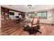 Spacious home office featuring built-in shelves, wood floors, and a stunning mountain view at 10638 E Hedgehog Pl, Scottsdale, AZ 85262