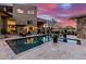 A sparkling pool with stone accents and a spa featuring desert views at 10638 E Hedgehog Pl, Scottsdale, AZ 85262