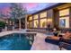 A luxurious pool with stone patios and elegant seating arrangements for outdoor relaxation at 10638 E Hedgehog Pl, Scottsdale, AZ 85262