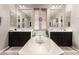 A bright bathroom featuring dual vanities, a window with blinds, and a soaking tub at 1152 W Horseshoe Ave, Gilbert, AZ 85233
