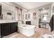 Bright bathroom featuring dual vanities, soaking tub, and makeup vanity area at 1152 W Horseshoe Ave, Gilbert, AZ 85233