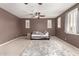 Spacious bedroom featuring neutral carpet, ceiling fans, and large windows for ample natural light at 1152 W Horseshoe Ave, Gilbert, AZ 85233
