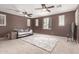 Spacious bedroom featuring neutral carpet, ceiling fans, and large windows for ample natural light at 1152 W Horseshoe Ave, Gilbert, AZ 85233