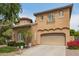 The front exterior features a neutral color palette and a circular turret above the two car garage at 1152 W Horseshoe Ave, Gilbert, AZ 85233