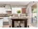 Bright eat-in kitchen featuring white cabinets, dark countertops, and a sliding glass door to the patio at 1152 W Horseshoe Ave, Gilbert, AZ 85233