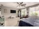 Spacious bedroom features plush carpeting, plenty of natural light, a ceiling fan, and a cozy seating area at 1152 W Horseshoe Ave, Gilbert, AZ 85233