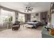 Serene bedroom with soft natural light, neutral tones, ceiling fan, and comfortable seating area at 1152 W Horseshoe Ave, Gilbert, AZ 85233