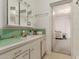 Bathroom with mint-green tiles, sink with vanity, and a view to the bedroom at 1217 E Edgemont Ave, Phoenix, AZ 85006