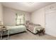 Bedroom featuring two beds, window with light-green curtains, and built-in storage at 1217 E Edgemont Ave, Phoenix, AZ 85006