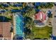 Aerial view of a community pool with lap lanes, lounge chairs, trees and a shade structure at 1488 E Sweet Citrus Dr, Queen Creek, AZ 85140