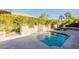 Private swimming pool with a charming rock water feature, creating a serene backyard oasis at 1488 E Sweet Citrus Dr, Queen Creek, AZ 85140