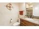 Powder room featuring a vanity sink, framed mirror and wood cabinets at 1488 E Sweet Citrus Dr, Queen Creek, AZ 85140
