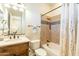 Full bathroom featuring a shower-tub, vanity sink, framed mirror and wood cabinets at 1488 E Sweet Citrus Dr, Queen Creek, AZ 85140