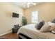 Comfortable bedroom with wood floors, a bench, and a large window with lots of natural light at 1488 E Sweet Citrus Dr, Queen Creek, AZ 85140