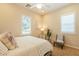 Cozy bedroom with neutral tones, plantation shutters, and a ceiling fan providing a relaxing atmosphere at 1488 E Sweet Citrus Dr, Queen Creek, AZ 85140