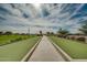Bocce ball court with manicured green lanes, and a clear blue sky at 1488 E Sweet Citrus Dr, Queen Creek, AZ 85140