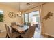 This dining room has a rustic table, comfortable seating for six, and sliding glass doors to a cozy patio at 1488 E Sweet Citrus Dr, Queen Creek, AZ 85140