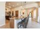 A modern kitchen boasts a breakfast bar with seating, sleek countertops, and ample cabinet space at 1488 E Sweet Citrus Dr, Queen Creek, AZ 85140
