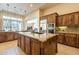 Spacious kitchen featuring granite countertops, stainless steel appliances, and a center island at 1488 E Sweet Citrus Dr, Queen Creek, AZ 85140