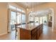 This kitchen boasts a large island with seating and sliding glass doors that lead to an outdoor entertaining area at 1488 E Sweet Citrus Dr, Queen Creek, AZ 85140