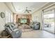 Cozy living room with comfortable seating, a ceiling fan, and sliding glass doors to the patio at 1488 E Sweet Citrus Dr, Queen Creek, AZ 85140