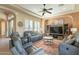 Comfortable living room features cozy seating, a ceiling fan, and a stylish rug, perfect for relaxation at 1488 E Sweet Citrus Dr, Queen Creek, AZ 85140