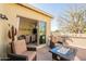 Inviting patio features comfortable chairs, a modern fire pit, and an outdoor grill for entertaining at 1488 E Sweet Citrus Dr, Queen Creek, AZ 85140