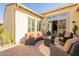 Comfortable outdoor patio with stylish seating, a modern fire pit, and sliding glass doors to the interior at 1488 E Sweet Citrus Dr, Queen Creek, AZ 85140