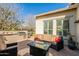 Charming outdoor patio with a comfortable sofa, grill, fire pit, and views of the landscaped yard at 1488 E Sweet Citrus Dr, Queen Creek, AZ 85140