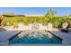 Refreshing pool with a decorative water feature and lush landscaping, creating a tranquil backyard oasis at 1488 E Sweet Citrus Dr, Queen Creek, AZ 85140