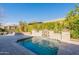 Beautiful pool featuring a stone waterfall, lush landscaping, and a relaxing outdoor setting at 1488 E Sweet Citrus Dr, Queen Creek, AZ 85140