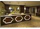 Inviting reception area with custom millwork, display shelving, pendant lighting and patterned tile floors at 1488 E Sweet Citrus Dr, Queen Creek, AZ 85140