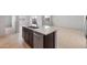 Kitchen island featuring a stainless steel sink, modern cabinetry, and granite countertops at 16505 N Comet Trl, Maricopa, AZ 85138