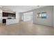 Bright, open-concept living room featuring tile floors and a modern kitchen with granite countertops at 16505 N Comet Trl, Maricopa, AZ 85138